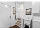 Well-lit laundry area with a sink, washer, dryer, and access to the stairs at 248 Montrose Dr, Mcdonough, GA 30253