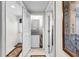 This laundry room features a stacked washer and dryer unit tucked away behind a white louvered door at 248 Montrose Dr, Mcdonough, GA 30253