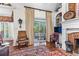 Elegant living room features hardwood floors, fireplace, and sliding door to the outdoor seating area at 248 Montrose Dr, Mcdonough, GA 30253