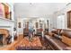 Comfortable living room with a brick fireplace, hardwood floors and stylish seating area at 248 Montrose Dr, Mcdonough, GA 30253