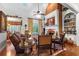 Bright living room showcasing a brick fireplace, leather sofa, and backyard views at 248 Montrose Dr, Mcdonough, GA 30253