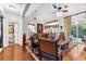 Cozy living room featuring a leather sofa, vaulted ceilings, fireplace, and sliding doors to the backyard at 248 Montrose Dr, Mcdonough, GA 30253