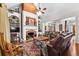Inviting living room features a brick fireplace, built-in shelving, and hardwood floors at 248 Montrose Dr, Mcdonough, GA 30253