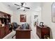 Spacious office with a large wooden desk, a ceiling fan, and a bookcase at 248 Montrose Dr, Mcdonough, GA 30253