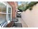 A cozy patio with seating area and lush greenery is partially enclosed by a white brick wall at 248 Montrose Dr, Mcdonough, GA 30253