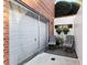 The partially enclosed patio adjacent to the garage includes a table and chairs for relaxing at 248 Montrose Dr, Mcdonough, GA 30253