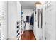 Walk-in closet with custom shelving for shoes, clothes, and accessories with hardwood floors at 248 Montrose Dr, Mcdonough, GA 30253