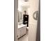 Clean bathroom with white fixtures, tiled walls, and a decorative round mirror at 5582 Brady Dr, Stone Mountain, GA 30087