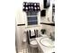 A compact bathroom featuring a toilet, small sink, and black and white decor at 5582 Brady Dr, Stone Mountain, GA 30087