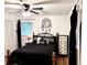 Cozy bedroom featuring dark bedding, a unique dreamcatcher, and ample natural light at 5582 Brady Dr, Stone Mountain, GA 30087