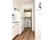 Well-lit laundry area featuring washer, dryer, overhead storage, and wood-look flooring at 5582 Brady Dr, Stone Mountain, GA 30087