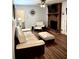Inviting living room with a brick fireplace, neutral decor, and wood-look floors at 5582 Brady Dr, Stone Mountain, GA 30087