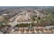 Wide aerial shot showcases a residential area featuring homes with well-kept lawns and tree-lined streets at 2126 Roberts View Trl, Buford, GA 30519