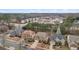 Aerial shot showcases a residential area featuring homes with well-kept lawns and tree-lined streets at 2126 Roberts View Trl, Buford, GA 30519