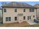 View of the backyard with a concrete patio, grill, manicured lawn, and the home's exterior at 2126 Roberts View Trl, Buford, GA 30519