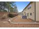 Landscaped backyard with retaining wall, patio, covered grill and two-story home at 2126 Roberts View Trl, Buford, GA 30519