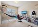 This bedroom is set up as a games room with a basketball hoop, a TV, and an gaming chair at 2126 Roberts View Trl, Buford, GA 30519