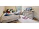 bedroom features neutral walls, a window, and decorative touches throughout at 2126 Roberts View Trl, Buford, GA 30519