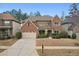 Charming two-story brick home featuring a well-manicured front yard and attached two-car garage at 2126 Roberts View Trl, Buford, GA 30519
