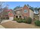 Attractive brick home showcasing manicured landscaping, a covered front porch, and an attached garage at 2126 Roberts View Trl, Buford, GA 30519