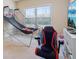 Fun game room with mounted basketball game, gaming chair, and media center setup at 2126 Roberts View Trl, Buford, GA 30519