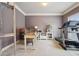 Bright home office features a wooden desk, shelving, and a treadmill for convenient workouts at 2126 Roberts View Trl, Buford, GA 30519
