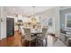 Bright eat-in kitchen featuring white cabinets, stainless steel appliances, and a hardwood floor at 2126 Roberts View Trl, Buford, GA 30519