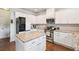 Spacious kitchen boasting white cabinets, granite countertops, stainless steel appliances, and a center island at 2126 Roberts View Trl, Buford, GA 30519