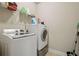 Laundry room featuring a front-load washer and dryer with storage shelves at 2126 Roberts View Trl, Buford, GA 30519