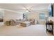 Large living room featuring neutral paint and a large sectional sofa and ceiling fan at 2126 Roberts View Trl, Buford, GA 30519