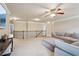 Upstairs living room with railing and neutral paint, large sectional sofa, and recessed lighting at 2126 Roberts View Trl, Buford, GA 30519