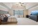 Spacious main bedroom with a tray ceiling, large windows, and neutral décor at 2126 Roberts View Trl, Buford, GA 30519