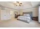 Spacious main bedroom with a tray ceiling, large windows, and neutral décor at 2126 Roberts View Trl, Buford, GA 30519
