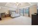 Spacious main bedroom with a tray ceiling, large windows, and neutral décor at 2126 Roberts View Trl, Buford, GA 30519