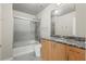 Bathroom featuring a granite vanity, sliding glass shower door, and modern fixtures at 250 Pharr Ne Rd # 208, Atlanta, GA 30305