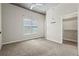 Bedroom with neutral carpet, large window with blinds, ceiling fan, and closet for storage at 250 Pharr Ne Rd # 208, Atlanta, GA 30305