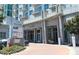 Beautiful condominium building with concrete accents, a circular driveway, and well-maintained landscaping at 250 Pharr Ne Rd # 208, Atlanta, GA 30305