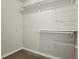 Walk-in closet with carpet flooring, built-in wire shelving, and ample storage space at 250 Pharr Ne Rd # 208, Atlanta, GA 30305