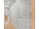 Bright hallway with hardwood floors and white doors leading to various rooms in the house at 250 Pharr Ne Rd # 208, Atlanta, GA 30305