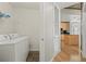 Laundry room with washer, dryer, and shelving, adjacent to a kitchen area at 250 Pharr Ne Rd # 208, Atlanta, GA 30305