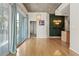 Living area with wood floors, large sliding glass door to balcony, and a decorated wall feature at 250 Pharr Ne Rd # 208, Atlanta, GA 30305