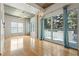 Bright living room with hardwood floors, exposed concrete ceiling, and a large sliding glass door leading to a balcony at 250 Pharr Ne Rd # 208, Atlanta, GA 30305