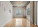 Minimalist living room featuring hardwood floors, neutral walls, and large windows at 250 Pharr Ne Rd # 208, Atlanta, GA 30305