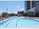 Large outdoor swimming pool provides residents with a relaxing and refreshing escape with surrounding lounge chairs at 250 Pharr Ne Rd # 208, Atlanta, GA 30305