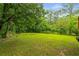 Expansive backyard, surrounded by mature trees, offers plenty of space for recreation and relaxation at 2521 Whites Mill Ln, Decatur, GA 30032