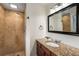 Updated bathroom featuring a stone shower and granite countertop vanity with a large mirror at 2521 Whites Mill Ln, Decatur, GA 30032