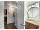 Hallway view into bathroom features a granite vanity with modern fixtures and a decorative mirror at 2521 Whites Mill Ln, Decatur, GA 30032