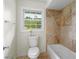 Bright bathroom with tiled shower, tub, window, and white commode at 2521 Whites Mill Ln, Decatur, GA 30032