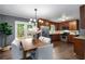 Modern dining area featuring an elegant light fixture, wood floors, and table with seating, enhancing the dining experience at 2521 Whites Mill Ln, Decatur, GA 30032