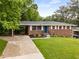 Charming brick home featuring a well-manicured lawn and tasteful landscaping at 2521 Whites Mill Ln, Decatur, GA 30032